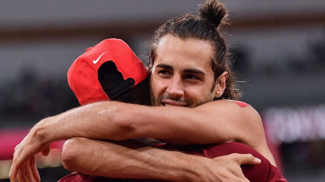 Gold medallists Italy's Gianmarco Tamberi (R) and Qatar's Mutaz Essa Barshim.