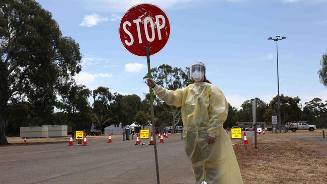 A staff member at the rapid antigen test pick-up station at Adelaide’s Southern Parklands off Greenhill Road. Picture: Emma Brasier