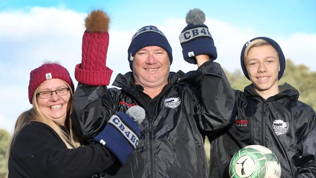 Para Hills Knights Soccer Club junior assistant coach Shane Hillman (centre), who is terminally ill with brain cancer, with his wife Deb and 15-year-old son Josh. The club is raising money and awareness for Carrie’s Beanies 4 Brain Cancer charity. Picture: AAP Image/Dean Martin.