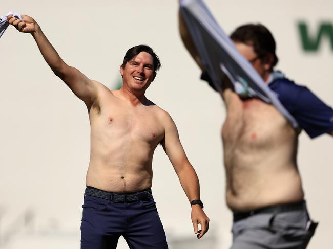 SCOTTSDALE, ARIZONA - FEBRUARY 13: Joel Dahmen and Harry Higgs of the United States take their shirts off on the 16th hole during the final round of the WM Phoenix Open at TPC Scottsdale on February 13, 2022 in Scottsdale, Arizona. (Photo by Mike Mulholland/Getty Images) *** BESTPIX ***