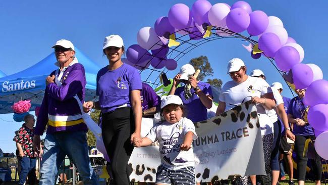 LANDERS LEAD: Bryan Vickery and Kaitlyn Landers, of team The Face of Mumma Trace, lead the lap for survivors and carers at Relay for Life in Roma on Saturday. Picture: Ellen Ransley