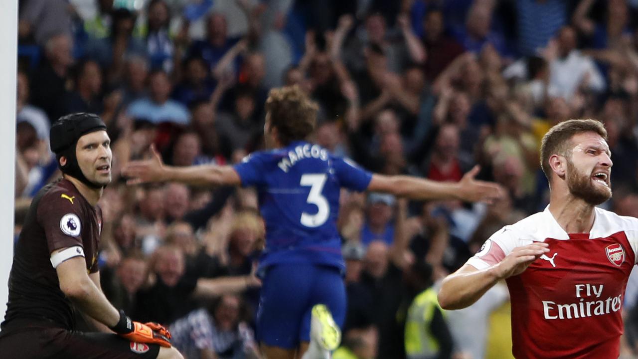 Arsenal's goalkeeper Petr Cech, left, and Arsenal's Shkodran Mustafi, right, react after Chelsea's Marcos Alonso, center, scores his side's third goal