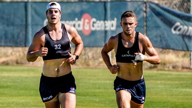 Darcy Fogarty and Lachlan Sholl running laps at training on Thursday morning. Picture: Mike Burton