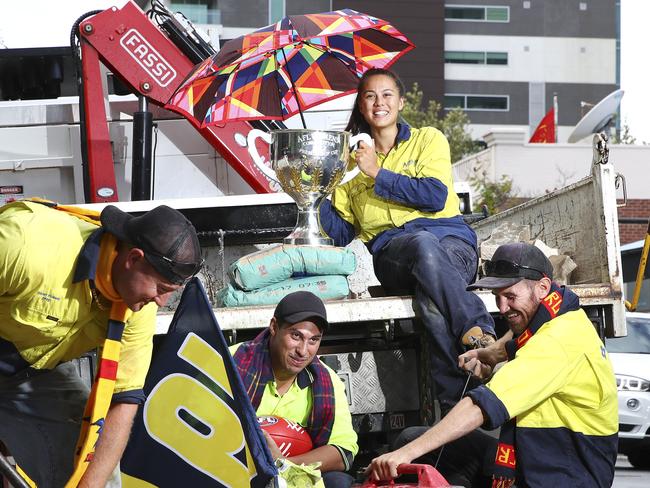 AFLW - AFLW Crows premiership player Justine Mules back to work for the Adelaide Council after her historic weekend. Work mates sit back with the premiership cup - Tristan Hussey 30yrs and Iain Adamson (both landscapers for Outside Ideas) and David Francesca who works for the Adelaide City Council. Picture Sarah Reed