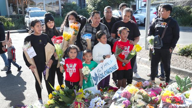 Family of Solomone Taufeulngaki, including his mother Solome and father Atunaisa (second and third from right), stand by a makeshift shrine outside Brimbank Shopping Centre. Picture: AAP