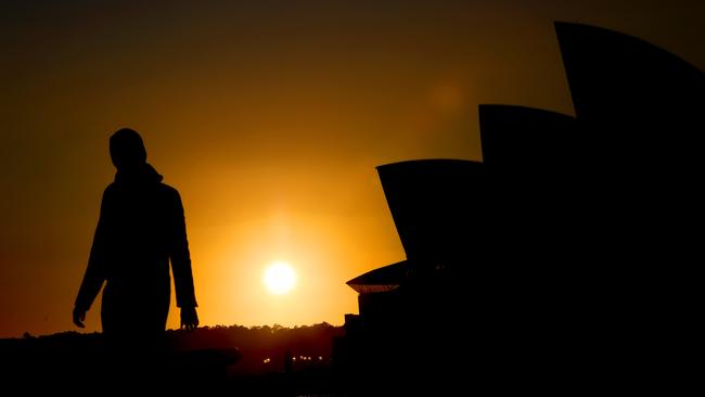 The sun rises next to the Sydney Opera House on a frosty Friday morning. Picture: NCA NewsWire / Damian Shaw