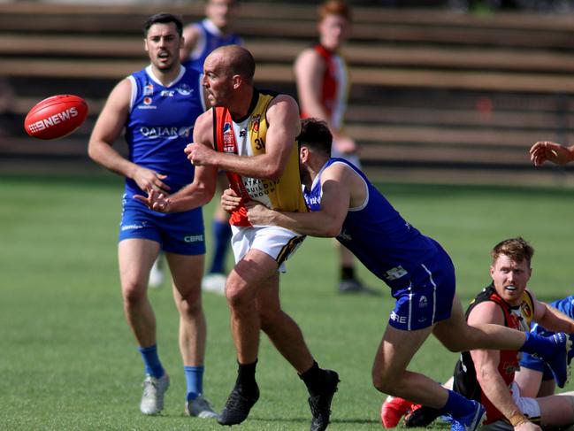 George Thring of the Saints handle balls out of a tackle. Adelaide Footy League divison one semi-final: St Peter's Old Collegians v Goodwood Saints.