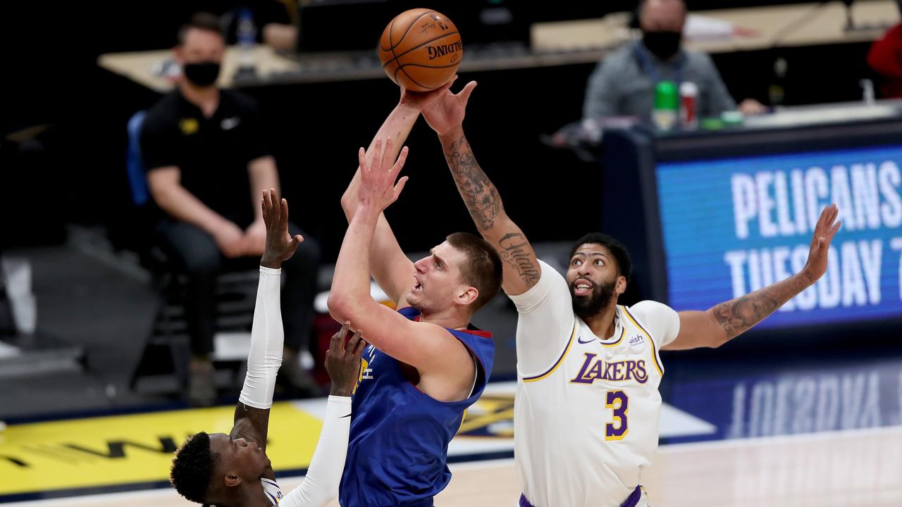 Anthony Davis (R) suffered an injury in a Lakers loss to Nikola Jokic’s (C) Denver Nuggets