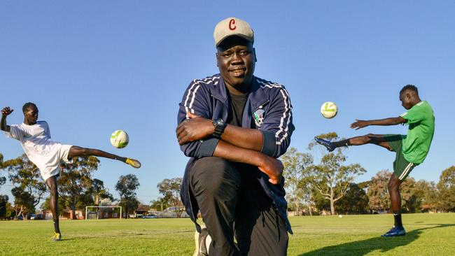 Nile United players Awal Dut (left) and Jok Akuien with coach Arok Akoi Arok at Kalara Reserve in Davoren Park. Photo: Brenton Edwards/AAP.