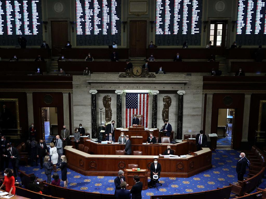 With the electronic vote tally projected on the wall above, Speaker of the House Nancy Pelosi (D-CA) presides over the vote to impeach U.S. President Donald Trump for the second time in little over a year in the House Chamber of the US Capitol. Picture: AFP