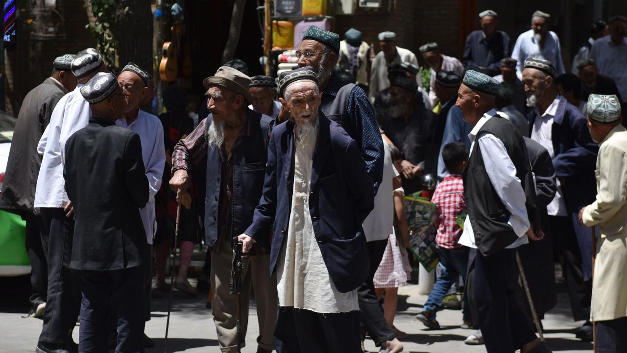 Uighur men are seen leaving a mosque after prayers in Hotan in China's northwest Xinjiang region in May 2019. Picture: Greg Baker/AFP