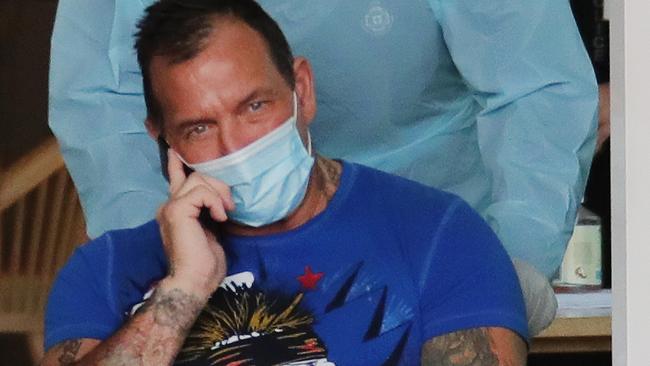 Shane Bowden is taken from a quarantine hotel to hospital yesterday for an infected gunshot wound. Picture Glenn Hampson.