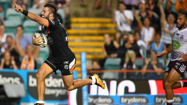 James Tedesco of the Tigers scores a try.