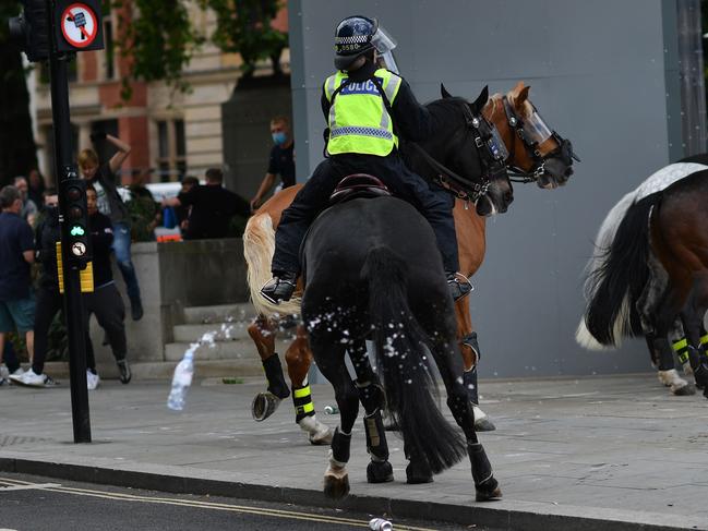 Bottles are thrown at mounted police by far-right protesters in London. Picture: AFP