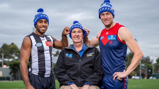 Neale Daniher with Collingwood’s Isaac Quaynor and Melbourne’s Tom McDonald. Picture: Jake Nowakowski