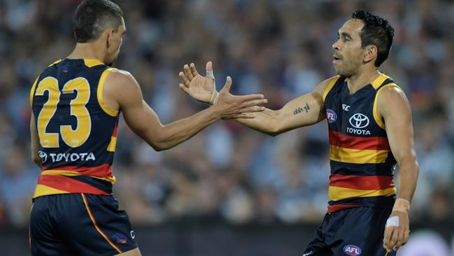 Charlie Cameron and Eddie Betts of the Crows celebrate a goal.