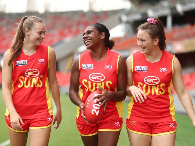 (L-R) Charlotte Hammans, Kitara Whap-Farrar and Ellie Hampson come together for the first time since signing for the Gold Coast Suns AFLW team. Picture: Chris Hyde/Getty Images.