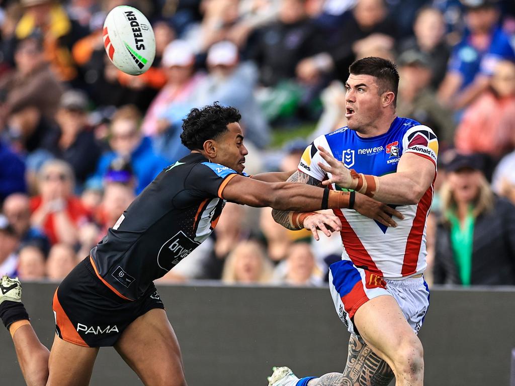 TAMWORTH, AUSTRALIA – MAY 11: Bradman Best of the Knights offloads contested by Jahream Bula of the Tigers during the round 10 NRL match between Wests Tigers and Newcastle Knights at Scully Park, on May 11, 2024, in Tamworth, Australia. (Photo by Mark Evans/Getty Images)