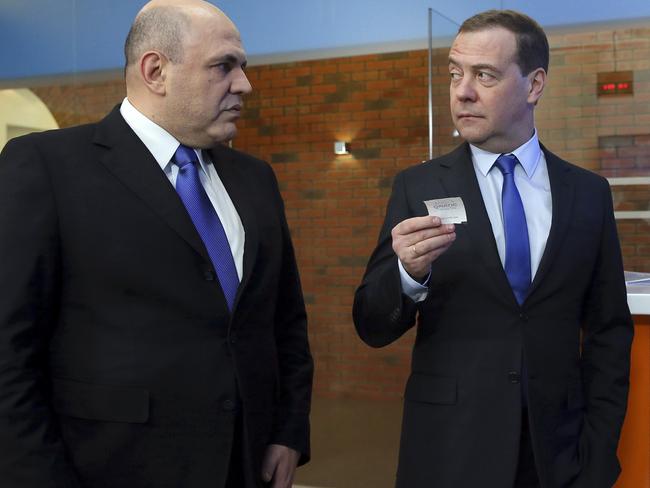 Russian Tax Service chief Mikhail Mishustin, left, listens to Russian Prime Minister Dmitry Medvedev. Picture: AP