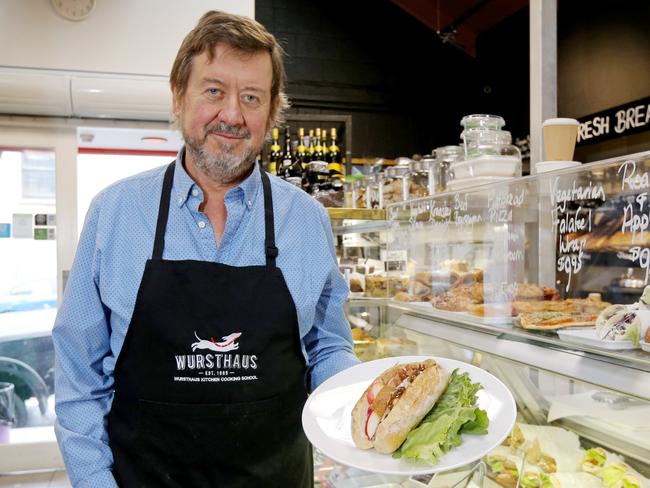 Wursthaus owner Peter Trioli with the roast pork and apple roll with crackling and gravy. Picture: PATRICK GEE