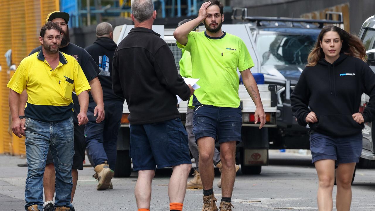 Workers outside a Probuild site in Elizabeth St. Melbourne. Picture: Ian Currie.