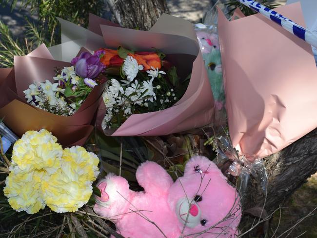 Flowers and bears left at the scene of the alleged murder on Bean St, Park Avenue on Saturday August 12, 2023. Picture: Aden Stokes