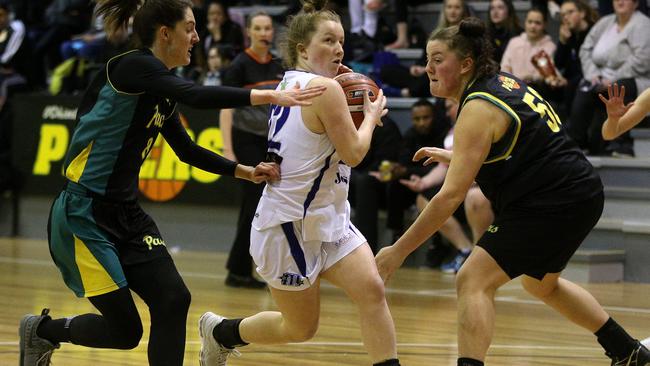 Rachael Main of Hawthorn drives between Jessica Scannell and Chloe Villiva of Whittlesea during the Big V Division 1 Women's Basketball match at Mill Park Basketball Stadium. Picture: Hamish Blair