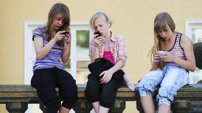 Smartphone obsessions are dumbing down Australian kids, OECD testing reveals