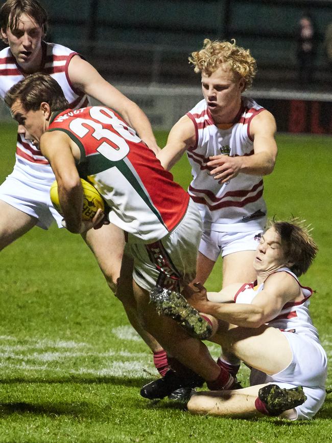 Henley midfielder Lachlan McNeil attempts to break away from a tackle by Princes forward Lewis Cowham. Picture: Matt Loxton