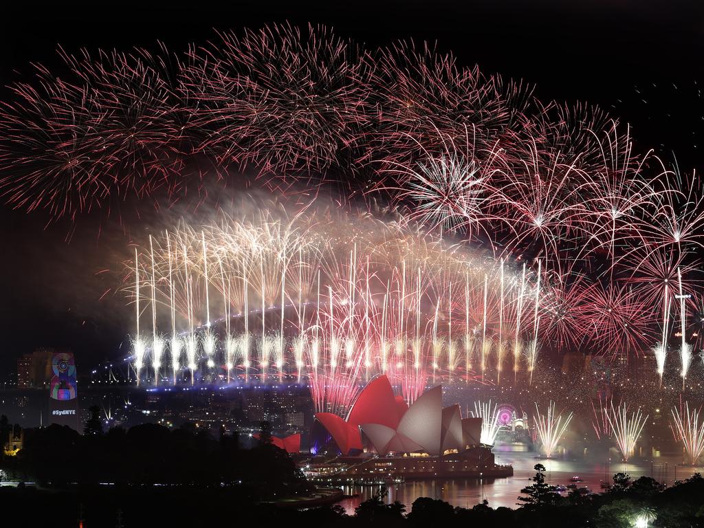 New Year's Eve 2018 - The midnight fireworks display over the Sydney Opera House and Sydney Harbour Bridge from a rooftop in Potts Point. Picture: Toby Zerna