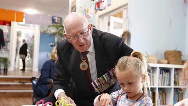 Sir Peter Cosgrove watching on as the children make Anzac Day craft at Little Diggers pre-school at an RSL Anzac Village at Narrabeen. Picture: Richard Dobson