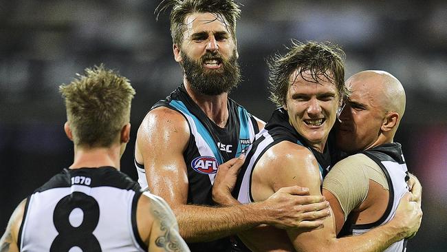 Jared Polec is mobbed by teammates after kicking a crucial goal in the last quarter. Picture: Getty Images