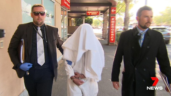 The murder suspect leaves Calvary Wakefield Hospital with two detectives. Picture: 7 News Adelaide