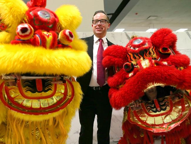 Qantas Group CEO Alan Joyce laughs as he stands next to two ceremonial dancing Chinese Lions during a photocall at the departure area in Sydney International Airport, Wednesday, Jan. 25, 2017.  Qantas have launched a direct flight service from Sydney to Beijing in China which coincides with the Chinese New Year. (AAP Image/David Moir) NO ARCHIVING