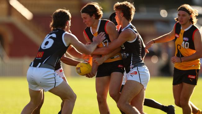 Harvey Langford fights his way through a tackle. (Photo by Graham Denholm/AFL Photos)