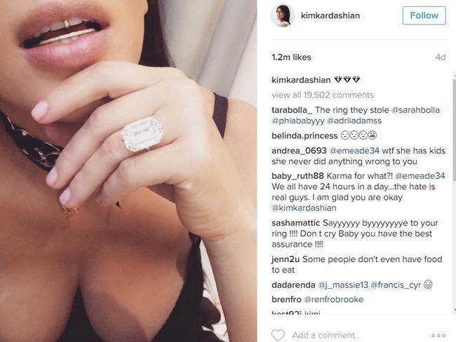 Kim flashed her diamond grill and engagement ring on Instagram just days before the robbery.