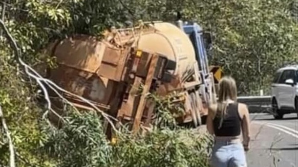 A truck carrying diesel has partially rolled into a ditch on the Captain Cook Highway north of Turtle Cove spilling fuel across the road causing it to be closed in both direction while cleanup occurs. Photo: Helen Wheels (Facebook)