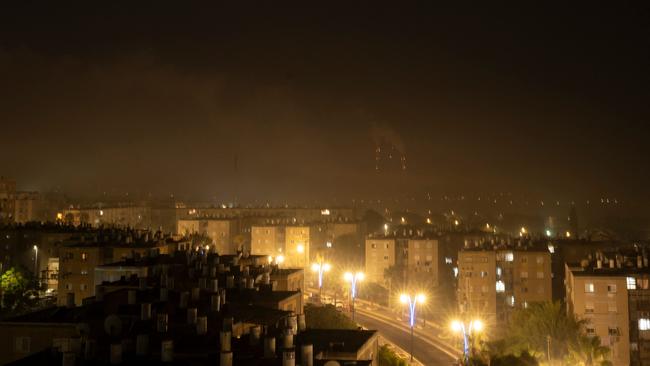 A dense cloud of smoke from the bombing of the Gaza Strip invades the Israeli border city of Ashkelon on the night of October 27. Picture: AFP