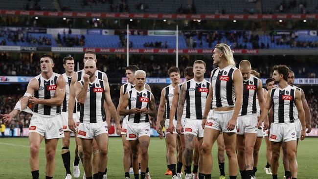 Dejected Collingwood players walk off the MCG after their third successive loss. Picture: Darrian Traynor/Getty Images