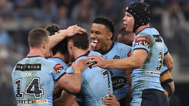 Daniel Tupou (face unseen) celebrates with teammates after scoring a try (Photo by Paul Kane/Getty Images)