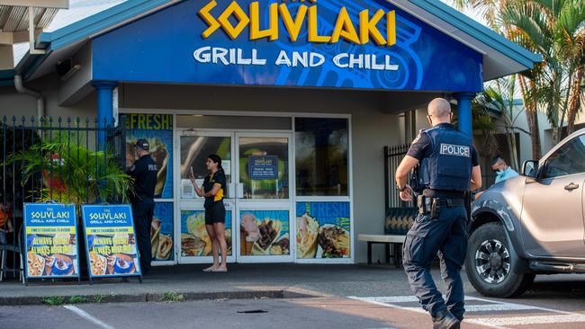 NT Police who remained onsite to ensure the premises ceased trading. Picture: Che Chorley