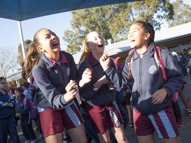 Students at Bonnyrigg Heights Primary School dance to the song 'Happy' by Pharrell Williams before the school bell goes. Picture: AAP Image/Melvyn Knipe