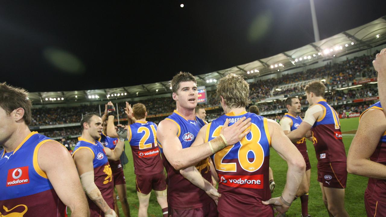 Jonathan Brown and Troy Selwood (#28) celebrate after a win.