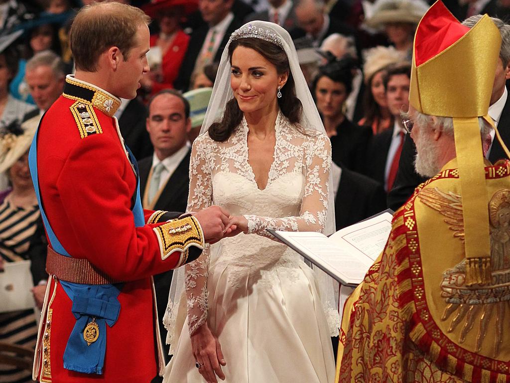 (Prince William (L) and Kate Middleton (C) exchange rings in front of the Archbishop of Canterbury during their wedding at Westminster Abbey, on April 29, 2011. Picture: AFP /Dominic Lipinski.