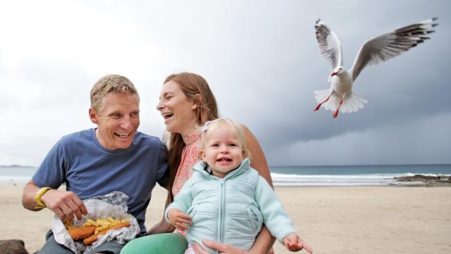 Fish and chips is the Gold Coast's most popular take away food. Matt and Angela Roberts enjoy some fish and chips at Snapper Rocks with daughter Millie. Picture: Luke Marsden.