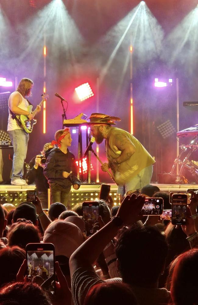 US singer Teddy Swims with young audience member on stage at Brisbane's Riverstage. Photo: Facebook.