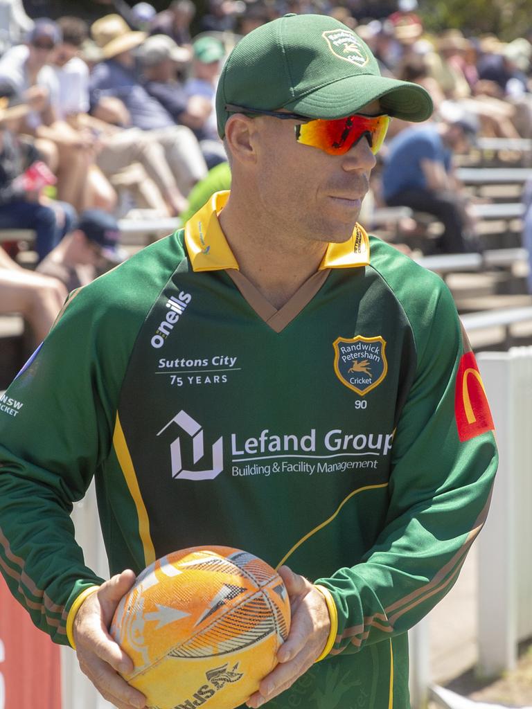 David Warner walking the boundary during a Sydney grade match.