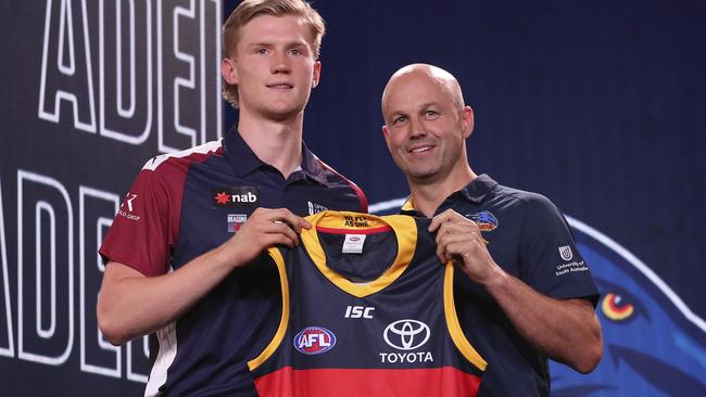 Adelaide coach Matthew Nicks presents Fischer McAsey with his new jumper.