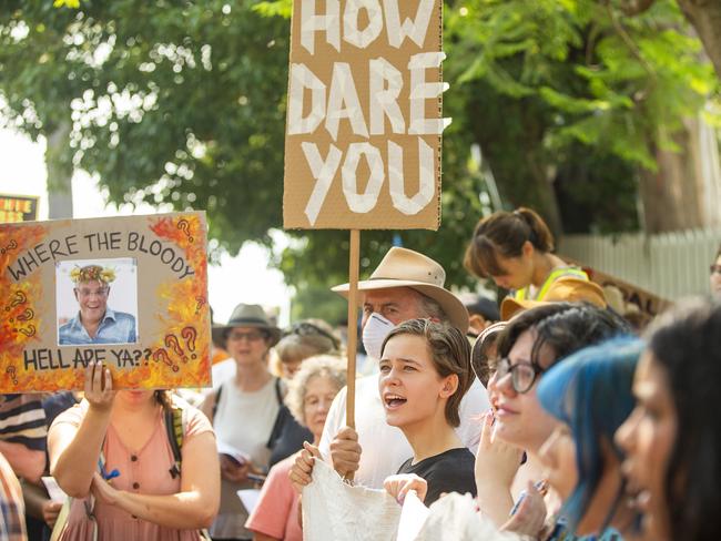 Protesters hold up banners during a protest at Kirribilli House on December 19, 2019 in Sydney, Australia. Picture: Jenny Evans/Getty Images