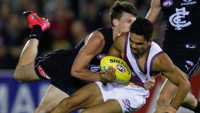 Charlie Cameron is tackled by Sam Walsh. Picture: Getty Images